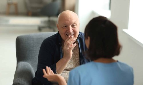 Young nurse visiting elderly woman at home