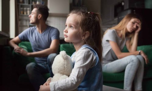 Upset, frustrated little girl tired of parents fight