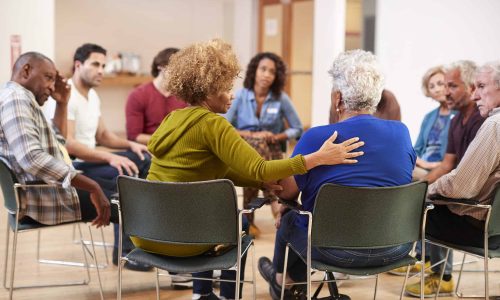 People Attending Self Help Therapy Group Meeting In Community Center